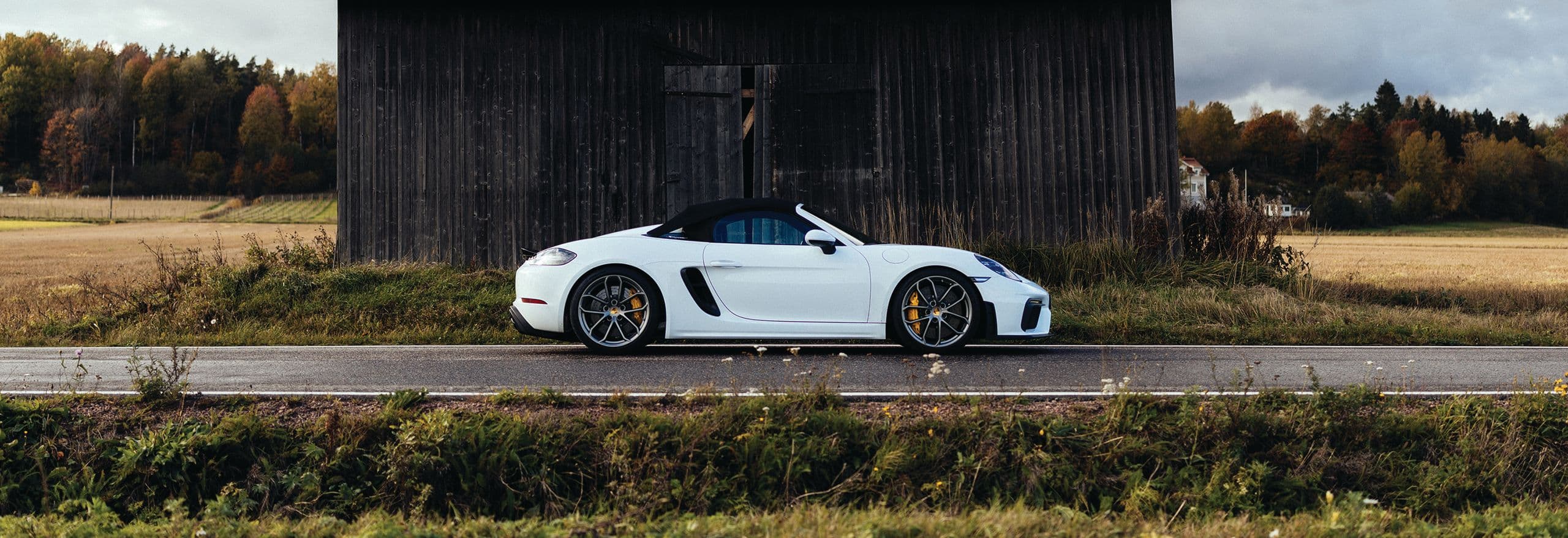 white sports car Porsche 718 on the road